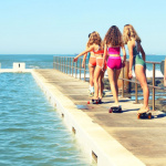 girls in swimmers at ocean pool