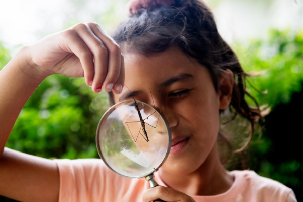 Girl holding magnifying glass 